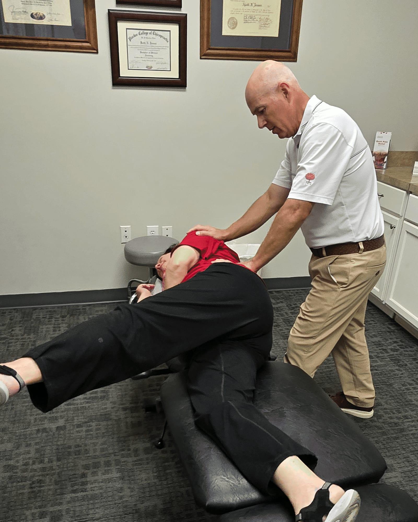 Dr. Keith Jensen performs Active Release Techniques on a patient's hip and leg at Mansfield Spinal Care in Mansfield, Texas.