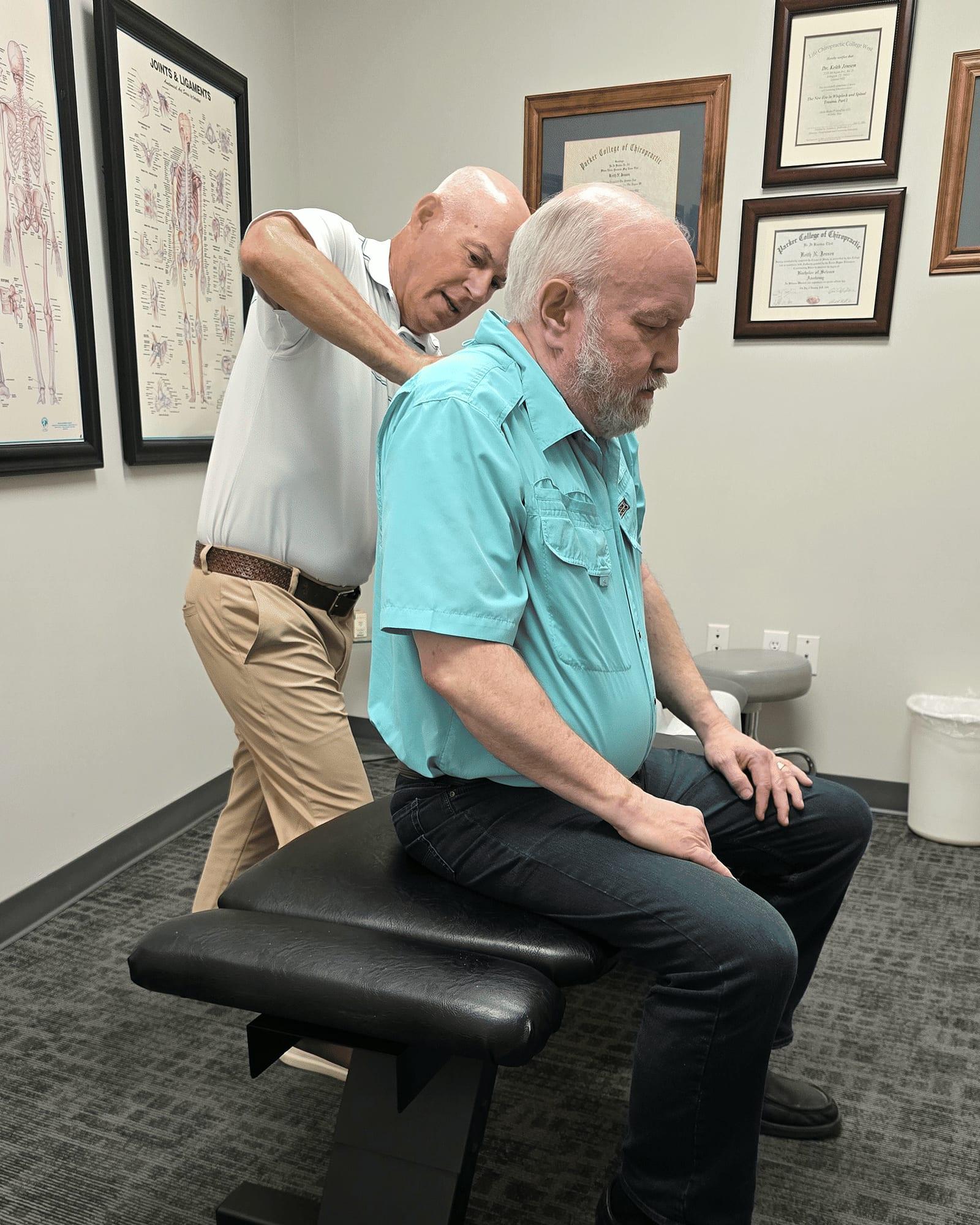 Dr. Keith Jensen performs Active Release Techniques on a patient's shoulder at Mansfield Spinal Care in Mansfield, Texas.