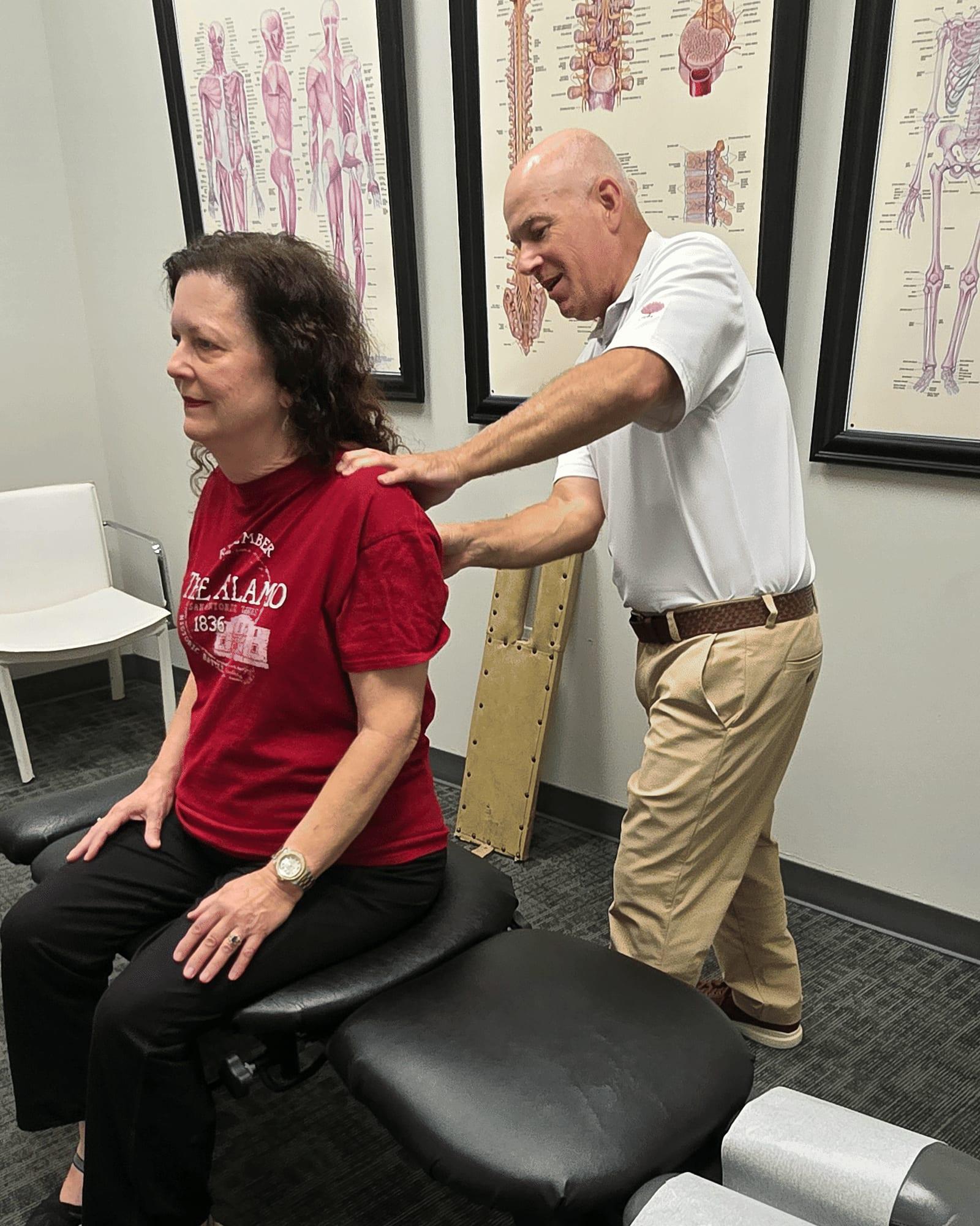 Dr. Keith Jensen performs Active Release Techniques on a patient's shoulder and trapezius muscle at Mansfield Spinal Care.