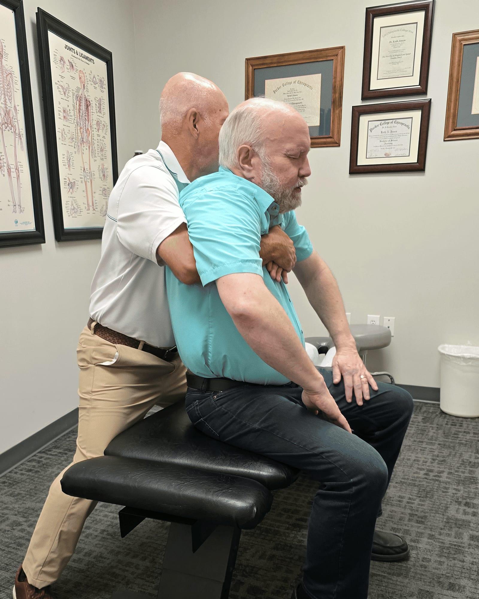 Dr. Keith Jensen adjusts a patient's upper back at Mansfield Spinal Care in Mansfield, Texas.