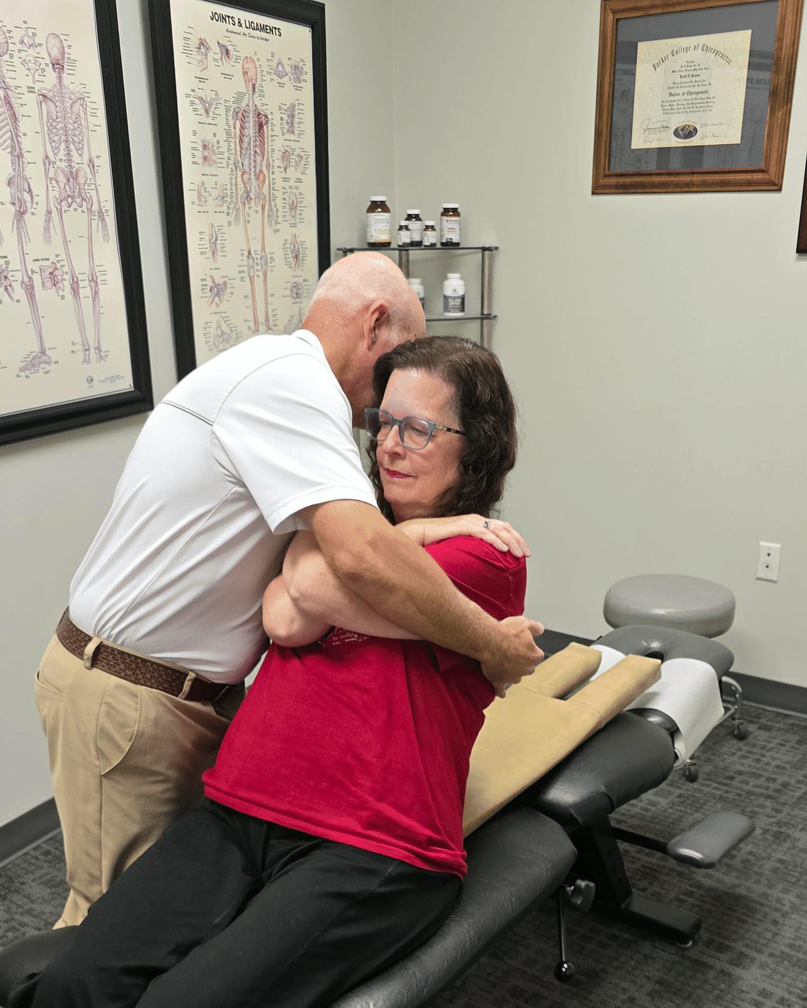 Dr. Keith Jensen adjusts a patient's upper back at Mansfield Spinal Care in Mansfield, Texas.