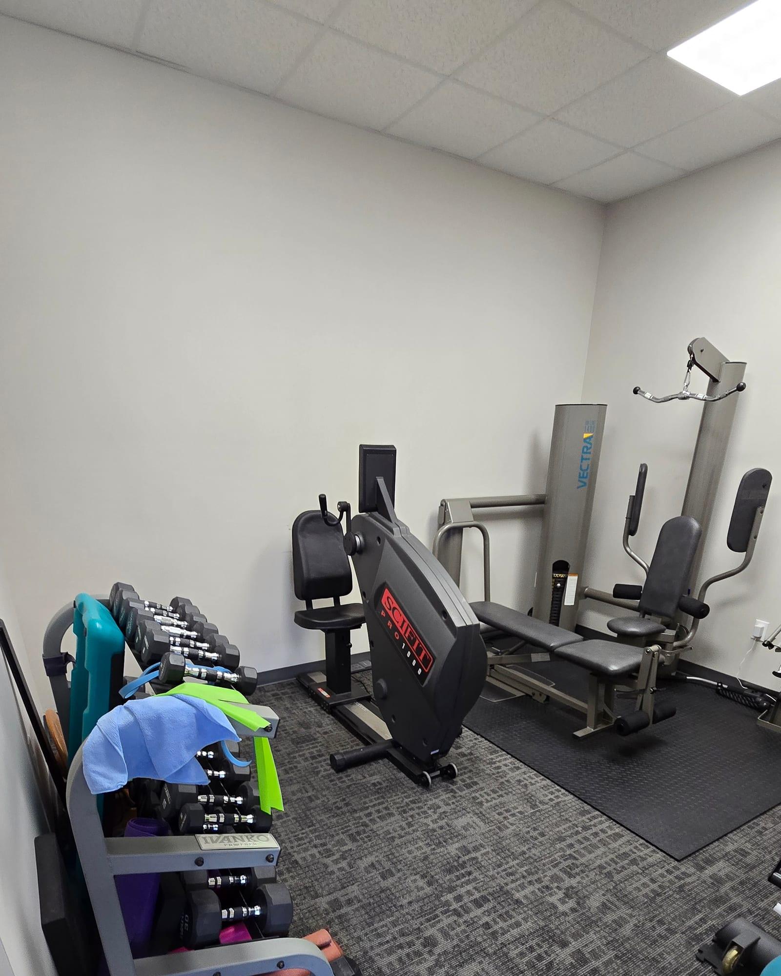 Free weights in the rehabilitation area at Mansfield Spinal Care in Mansfield, Texas.